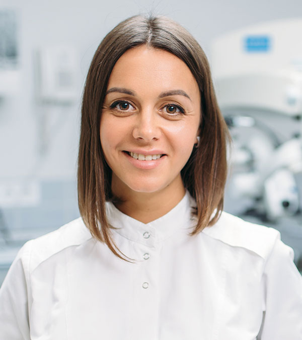 smiling-female-dentist-dental-clinic-JBF6ZRX